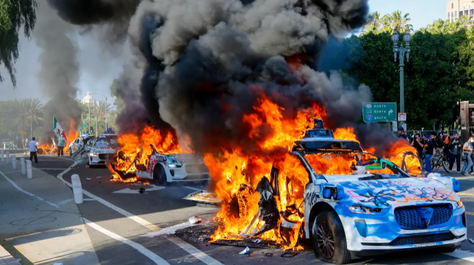Photos show Waymo vehicles on fire during LA protests as company cuts service